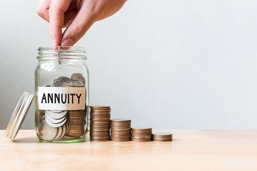 adding coins to a jar labeled annuity to save up money